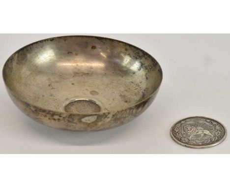 An Iranian fifty dinars Medal of Valour coin, 1900, diameter 3.7cm, and a white metal dish, set with a one riyal coin, diamet