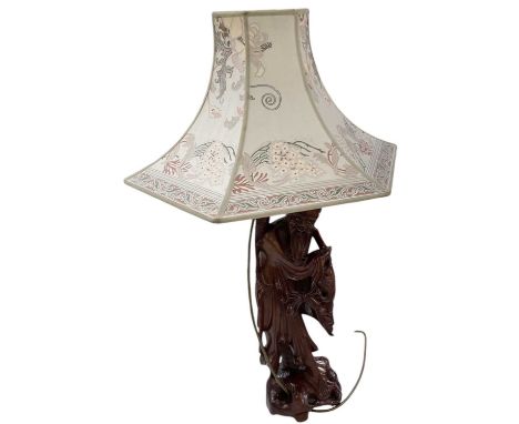 An early 20th century Chinese carved root wood table lamp modelled as a bearded gentleman fishing, height to top of fitment i