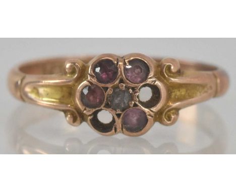 A 9ct yellow gold diamond and pink stone set flower head ring (lacking two stones), size O, weight 2g.