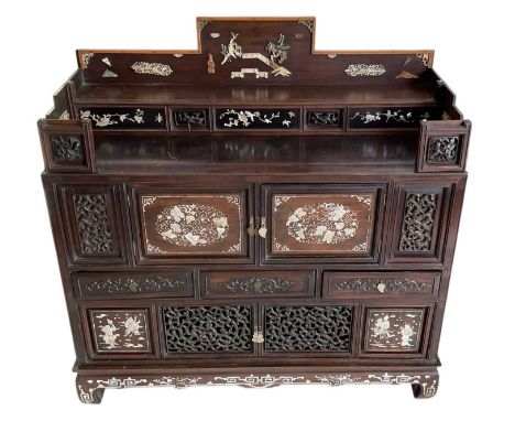 A late 19th/early 20th century hardwood cabinet of small proportions, decorated with panels of mother of pearl and small bone