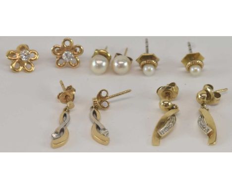 A pair of 9ct yellow gold pearl set stud earrings, a pair of yellow metal pearl set stud earrings, a pair of yellow metal dia