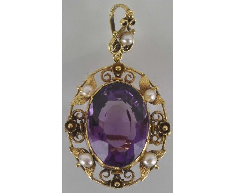 A 15ct gold Victorian style brooch, with central large cut amethyst and gold filigree outer border, also set with four small 