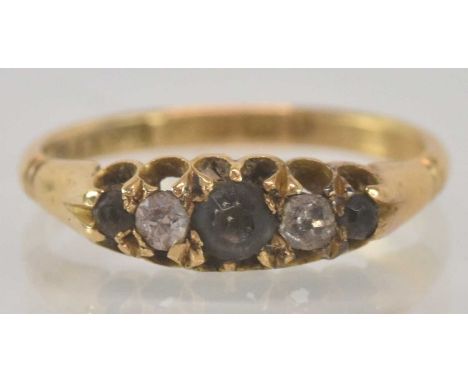 An 18ct yellow gold diamond and white stone three stone ring, size J, weight 2.1g.