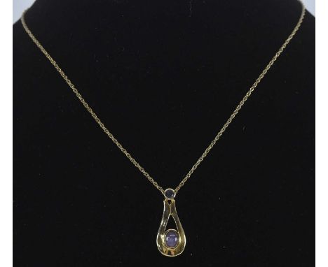 A 9ct yellow gold cabochon amethyst and sapphire set pendant, length approx 2cm, on a 9ct yellow gold fine link chain, approx