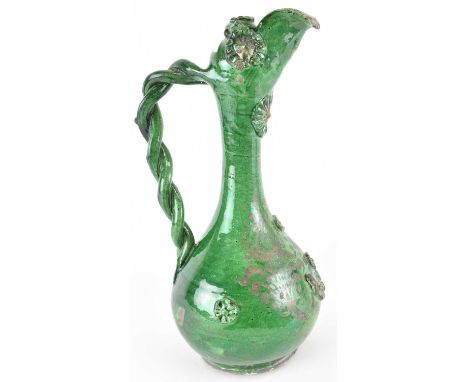 A 19th century Turkish Ottoman Canakele green glazed ewer, with beaded handle and silver overlaid decoration, height 34.5cm.