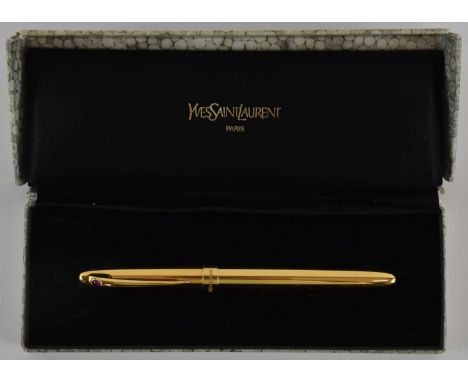 YVES SAINT LAURENT; a gold plated fountain pen, with 18ct yellow gold nib, the pen lid set with small cabochon ruby, length 1