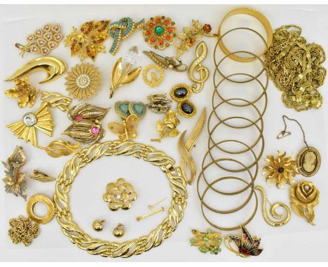 A good collection of gold coloured metal jewellery including brooches, earrings, bangles, necklaces, etc.