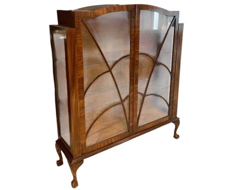 A 1930s Art Deco walnut veneered display cabinet, with pair of glazed doors enclosing two adjustable glass shelves, raised on