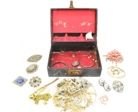 A jewellery box containing a quantity of costume jewellery, including an Arts and Crafts style square brooch with mottled blu
