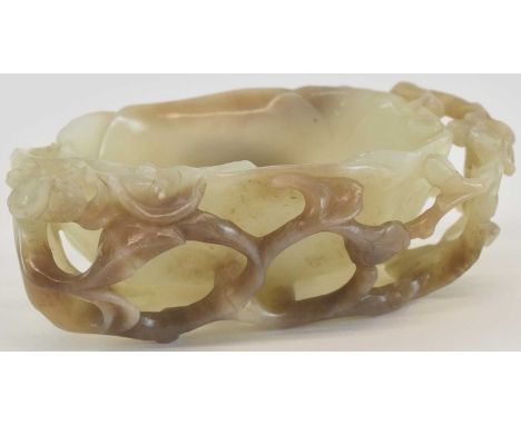 A large 19th century Chinese jade brush washer, modelled as a leaf with pierced floral and branch frame, russet inclusions, l