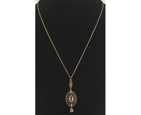 An early 20th century yellow metal aquamarine and seed pearl set pendant, suspended on a yellow metal fine link necklace, len