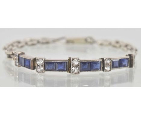A white metal bracelet, with four links each set with two square cut sapphires, separated by five columns of two set white st