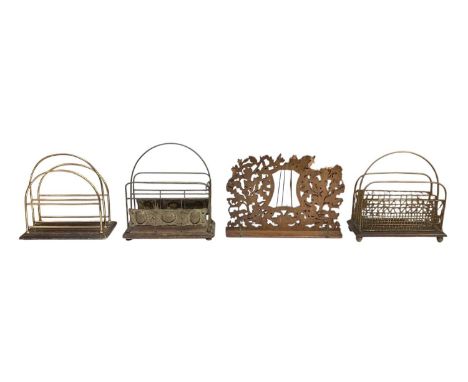 An early 20th century Art Nouveau brass magazine rack, two further brass framed magazine racks and a mahogany fret carved mus