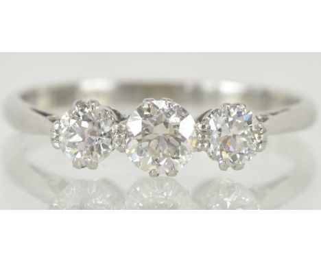 An 18ct white gold three stone diamond set ring, the central diamond approx 0.3ct, flanked by two smaller diamonds each appro