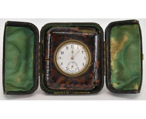 PARKINS &amp; GOTTO OF OXFORD STREET, LONDON; an early 20th century cased bakelite travelling clock, the white enamel dial se