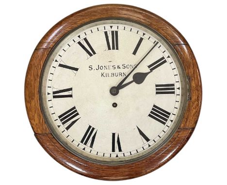 S JONES &amp; SONS OF KILBURN; an early 20th century oak cased railway clock, the white painted dial set with Roman numerals 
