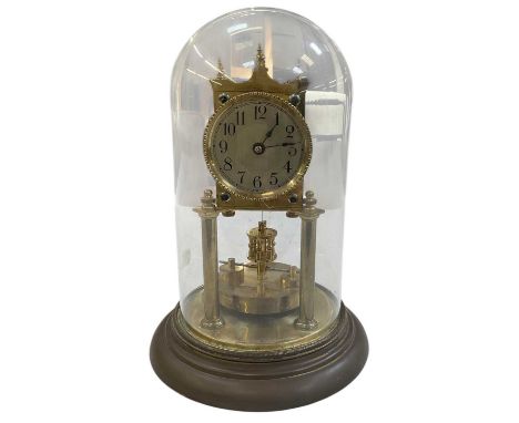 An early 20th century German brass torsion clock under glass dome, height including dome 29cm.