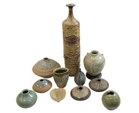 A collection of eleven pieces of studio ceramics, including a large celadon glazed tri-handled vase, inscribed to the base 'D