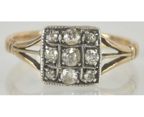 An Art Deco 18ct gold ring, the square table set with three rows of three claw set diamonds (various sizes), on three-way spl