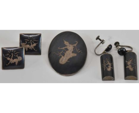 A suite of Thai Siam sterling silver niello work jewellery, comprising oval brooch, 5 x 3.2cm, a pair of square clip-on earri