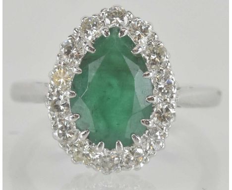 An 18ct white gold emerald and diamond cluster ring, the central tear drop shaped emerald approx 1.5ct, size I, approx 3.9g.