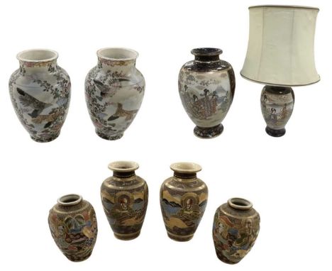 A large Japanese Satsuma baluster form vase, the large panels decorated with female figures amongst foliage and landscape, on