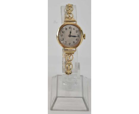 A 9ct yellow gold lady's wristwatch, the silvered dial set with Arabic numerals and subsidiary seconds, on a gold plated stra