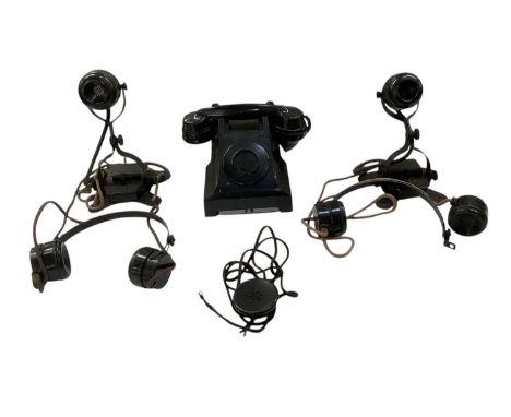 A pair of GEC WWII military bakelite telephones, with headsets, and a further military bakelite telephone (with blank dial) (
