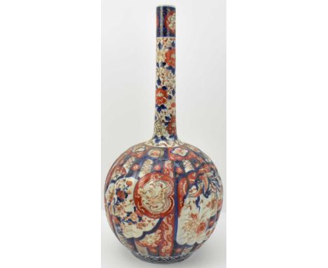 A large 19th century Japanese vase of onion shape with tall narrow cylindrical neck and ribbed body, decorated with the Imari