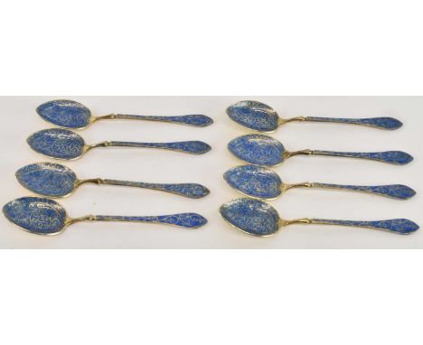 A set of eight 800 grade silver gilt blue enamelled coffee spoons, all length 9.5cm, combined approx 2.05ozt/64.8g.
