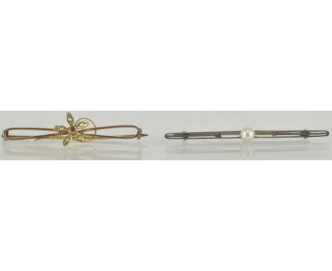 Two 9ct gold brooches, comprising a yellow gold example with central flower set with ruby and seed pearls, length 4.5cm, and 