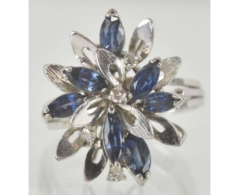 A contemporary 18k white gold floral cluster ring, set with sapphire and claw set small diamonds, size L, approx 4.2g.