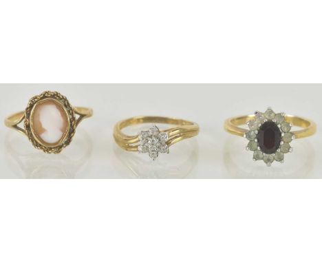 Two 9ct gold dress rings, one with bezel set cameo, size L, one tiny diamond floral cluster, size L and a yellow metal ring w