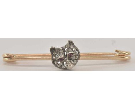 A yellow metal bar brooch, with diamond encrusted model of a fox's head, set with cabochon ruby eyes, length 4.5cm, approx 3.