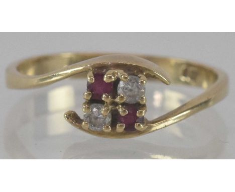 A 9ct yellow gold ruby and diamond crossover cluster ring, size O, approx weight 2.1g.