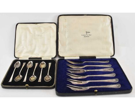 WILLIAM HUTTON &amp; SONS LTD; a cased set of six George V hallmarked silver coffee spoons, Sheffield 1931, and a cased set o
