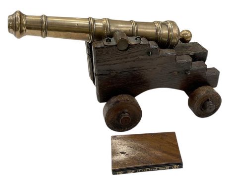 A 19th century brass table model of a ship's cannon, 'Relic of the Royal George, Sunk 1782, Raised 1840', mounted on stepped 