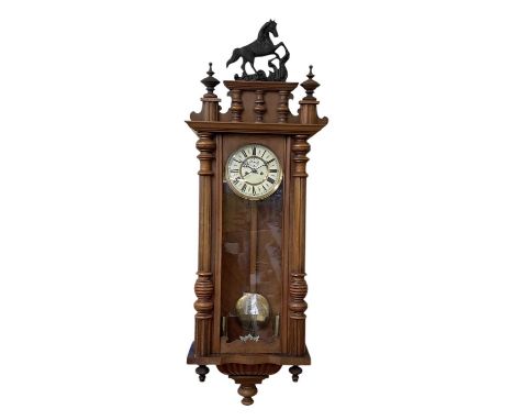 A late 19th/early 20th century walnut cased Vienna type regulating wall clock, the white enamel dial set with Roman numerals,