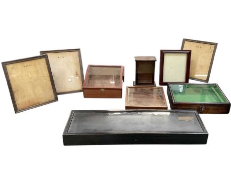 A modern rectangular ebonised tabletop display cabinet, with hinged lid, 76 x 23cm, four further tabletop display cabinets, a