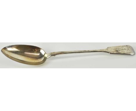 An early 19th century hallmarked silver basting spoon, with rat tail bowl, family motto crest to the front handle depicting a