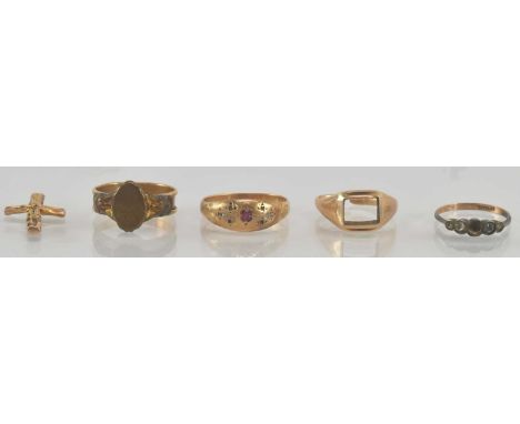A yellow metal ruby set signet ring, size P, a yellow metal signet ring (lacking square cut stone) (cut), a further yellow me
