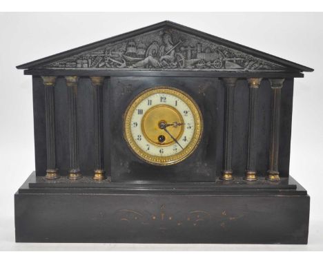 A Victorian black slate mantel clock of architectural form, the enamelled chapter ring showing Arabic numerals flanked by 6 r