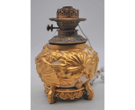 A Royal Worcester porcelain oil lamp font, relief decorated with gilt lily pads, puce mark to the underside, later converted 