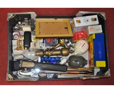A box of miscellaneous items to include a brass oil lamp, piggy bank, cigarette cards, etc