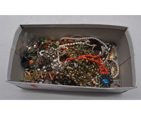 A box of miscellaneous costume jewellery to include coin bracelet, beaded necklaces, paste set brooch, faux coral beaded neck