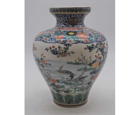 An early 20th century Japanese earthenware vase, enamel decorated with birds amongst flowers, three-character enamel mark to 