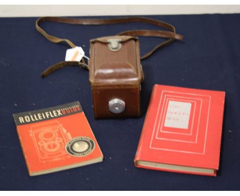 A Rolleiflex Compur-Rapid boxed camera, in leather case; together with a Rollieflex and Rolliecord camera guide; and a Rollie