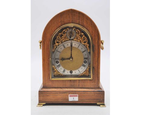A late 19th century lancet shaped rosewood mantel clock, the boxwood strung case, with twin axe head side handles, the brass 