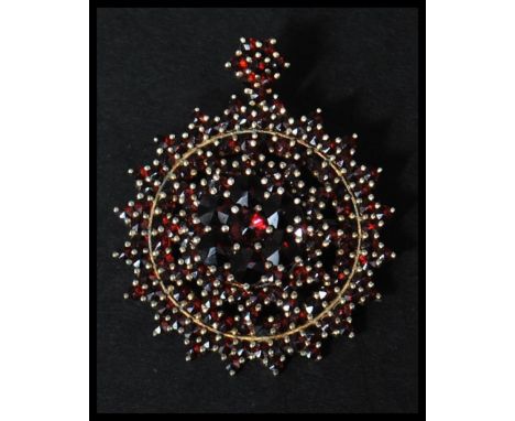 A 925 silver vermeil bohemian garnet pendant brooch having a roller clip clasp and garnet cluster articulating bale. Marked H