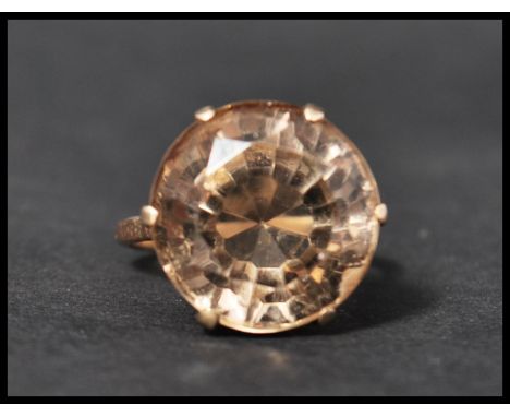 A vintage 9ct gold dress ring set with a large round cut smokey quartz. Marked 9ct, tests 9ct gold. Size S. Total weight 8.9g